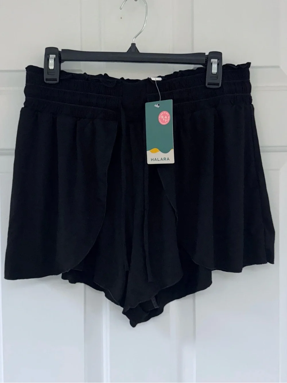 New Halara stretchy black shorts with tie at waist and flowy panels on the front